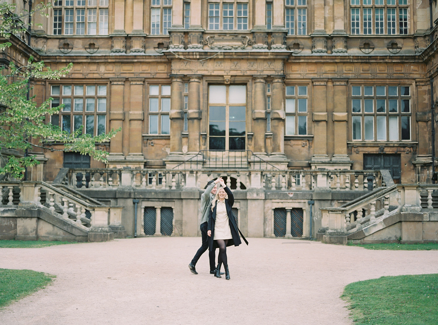 couple dance in front of wollaton hall in nottingham