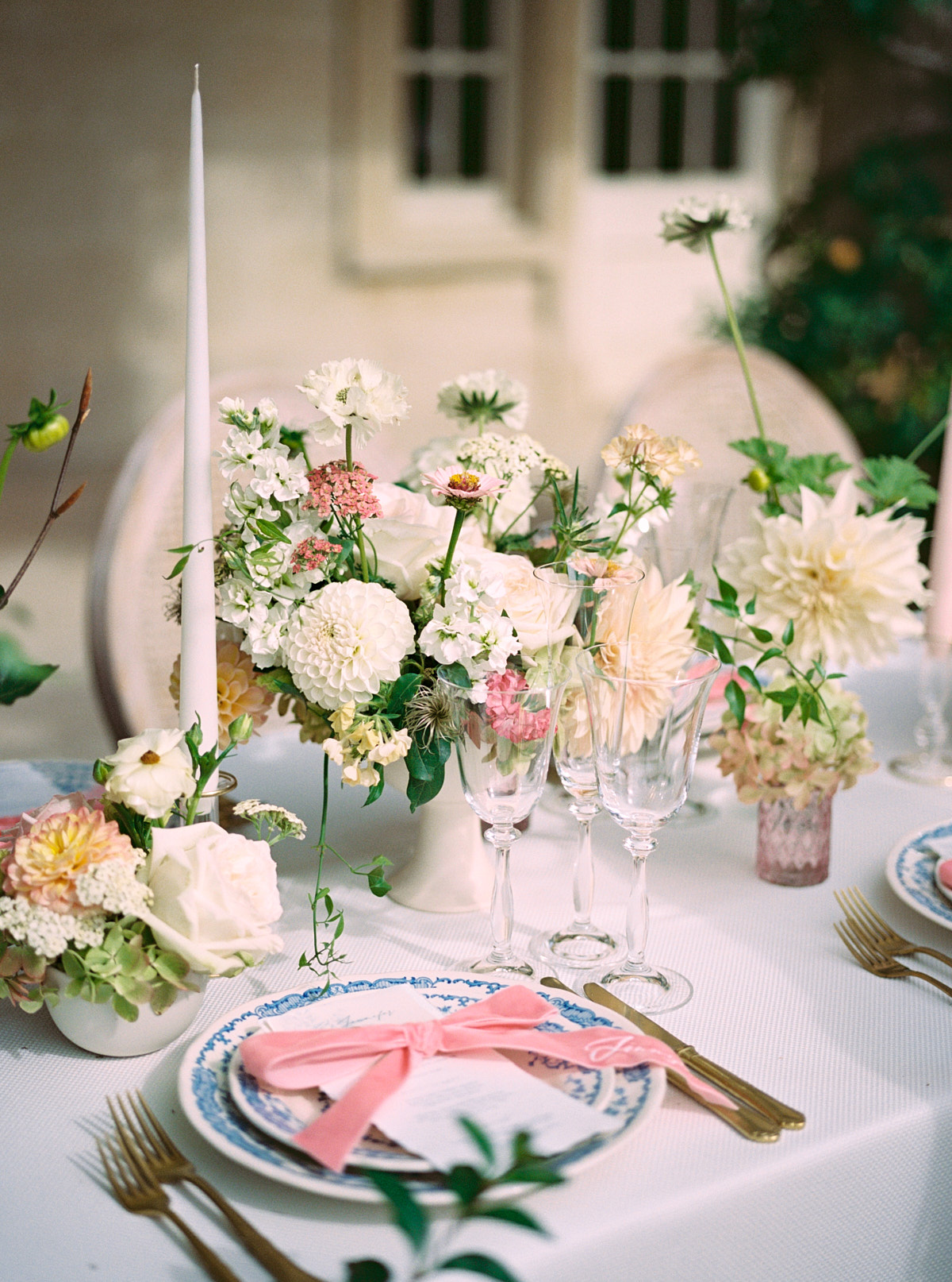 wedding table with tall candles and monogrammed napkins 