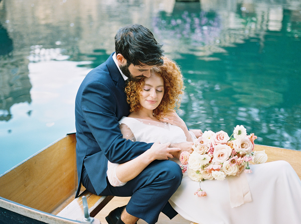 bride and groom portrait in the boat at wedding venue in cotswolds