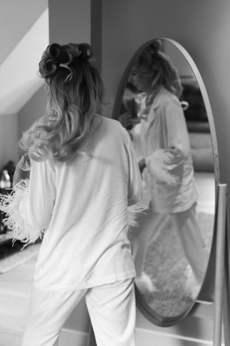 candid black and white photo of the bride walking in the cottage
