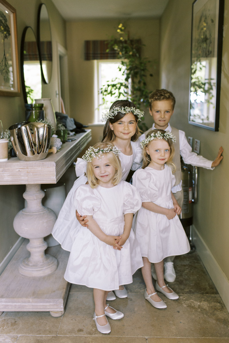 little flower girls and ring bearer in the cottage before wedding ceremony