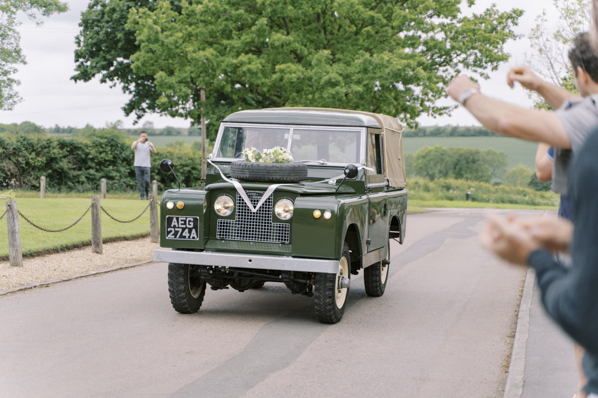groom arrives in the stylish green colour land rover