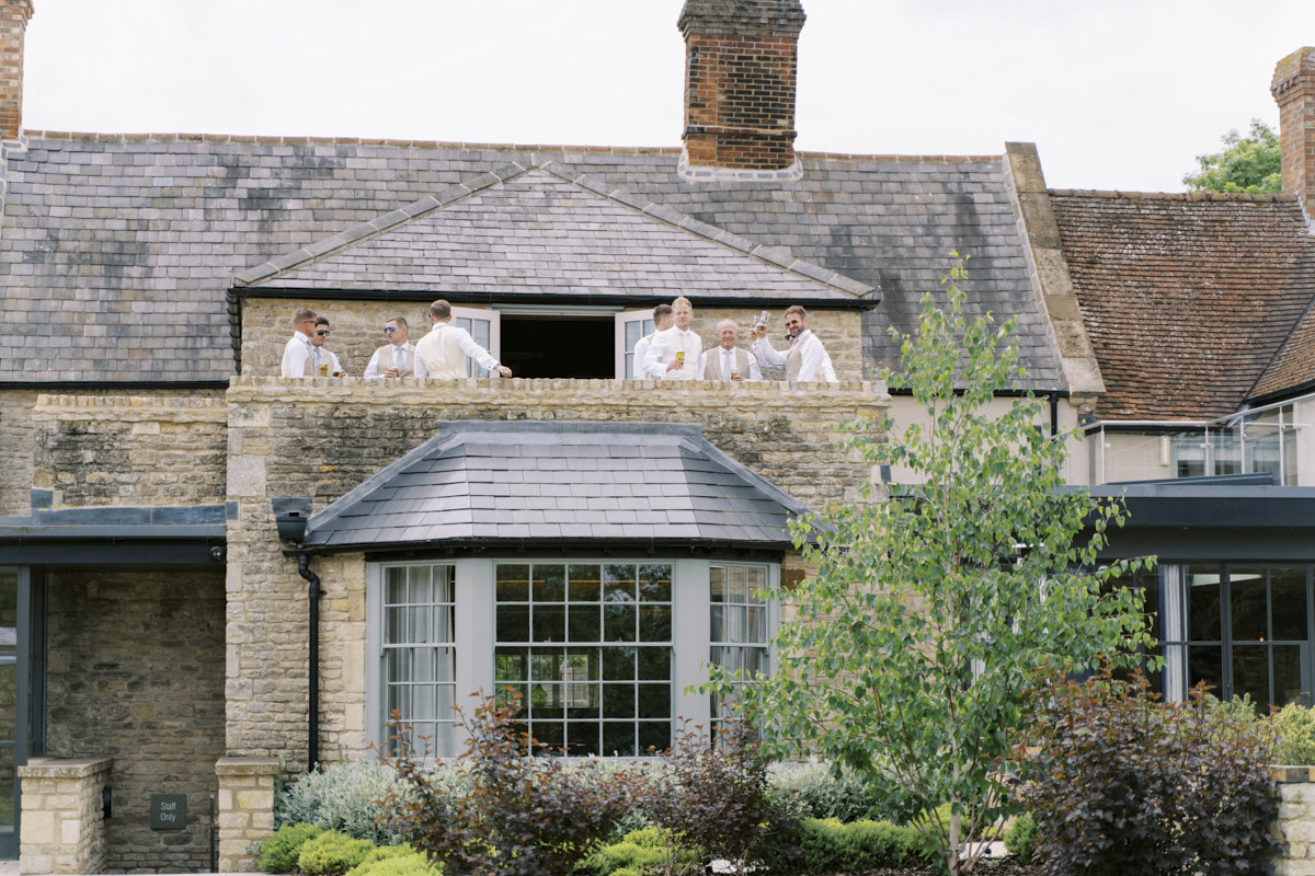 groom with her groomsmen getting ready at the falcon hotel in castle ashby