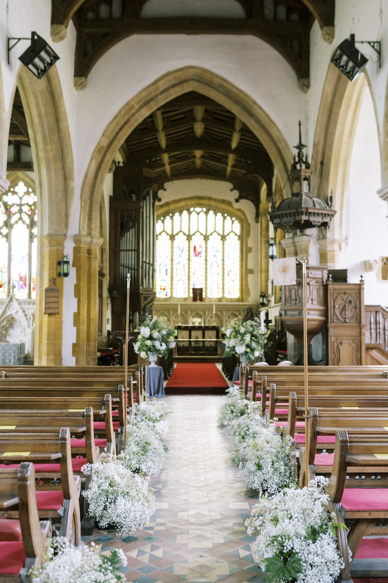 beautiful flowers inside the st mary magdalene church wedding in castle ashby