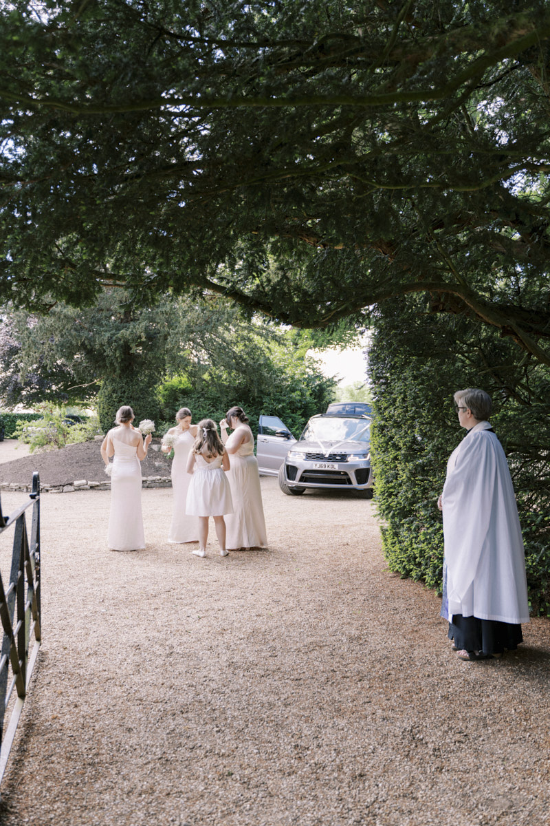 bridal party arriving at the wedding ceremony in castle ashby