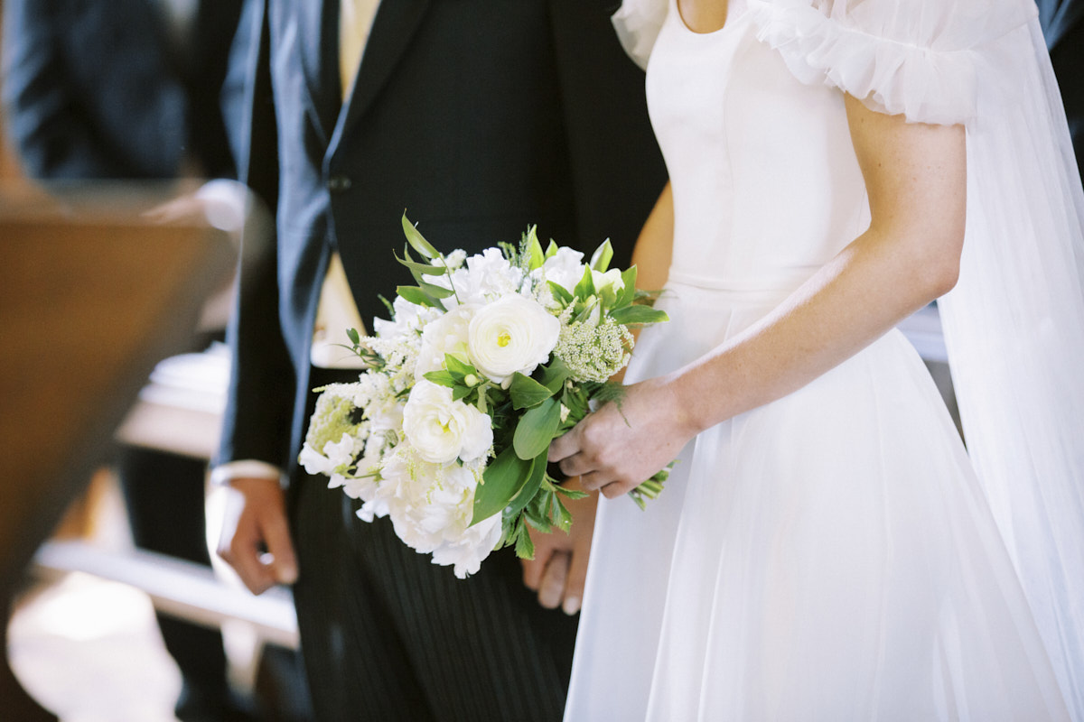bride holding small romantic wedding flower bouquet