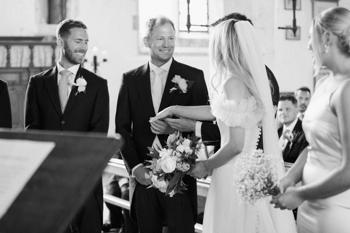 black and white photo of the groom smiling at the beautiful bride