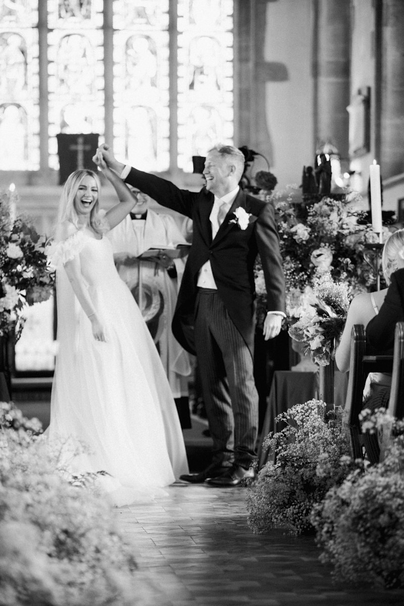 black and white photo of the bride and groom after exchanging the rings