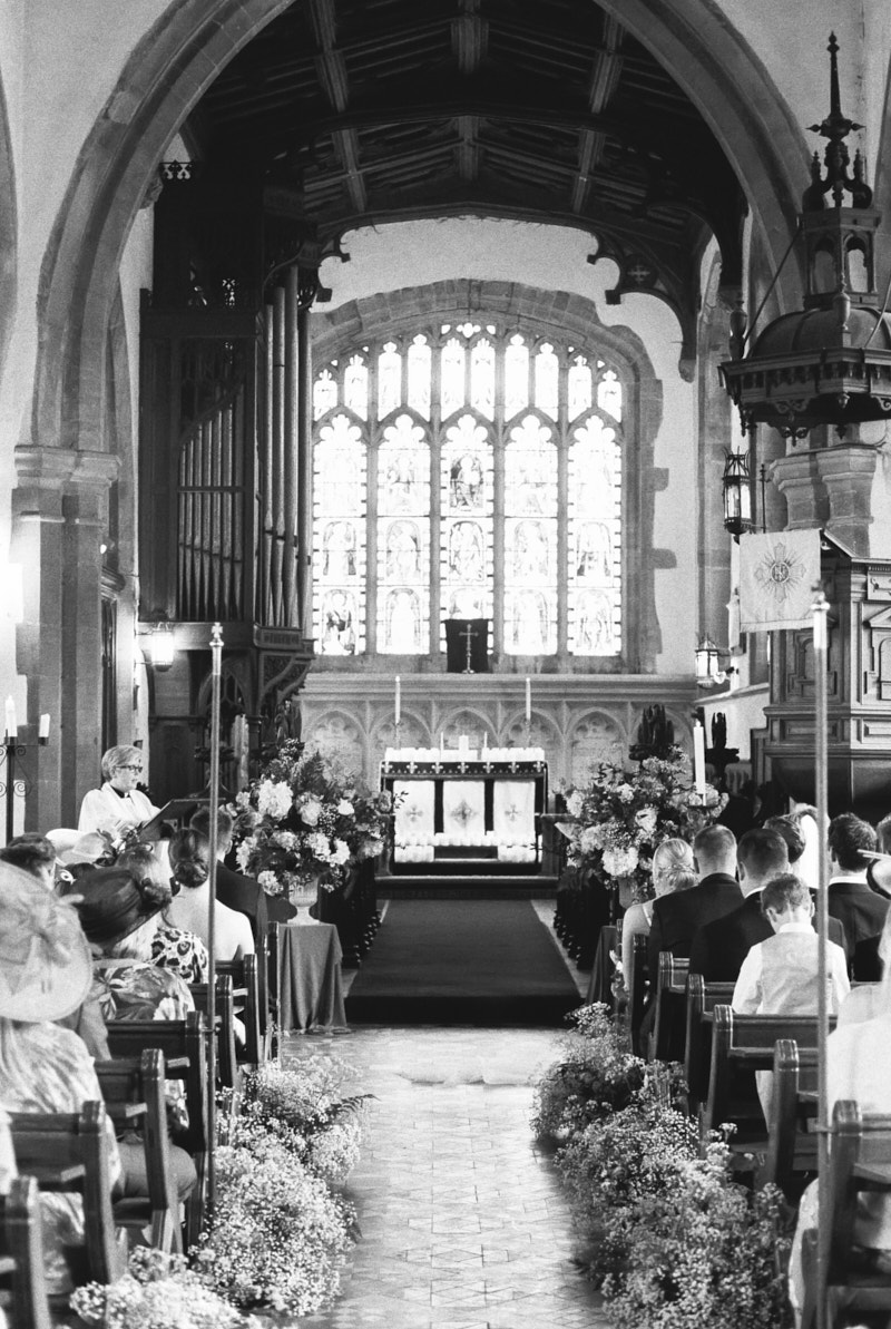 black and white photo of the st mary magdalene church in castle ashby during the wedding