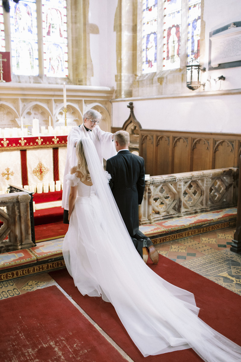 stunning bride and groom at the altar during church wedding ceremony in castle ashby
