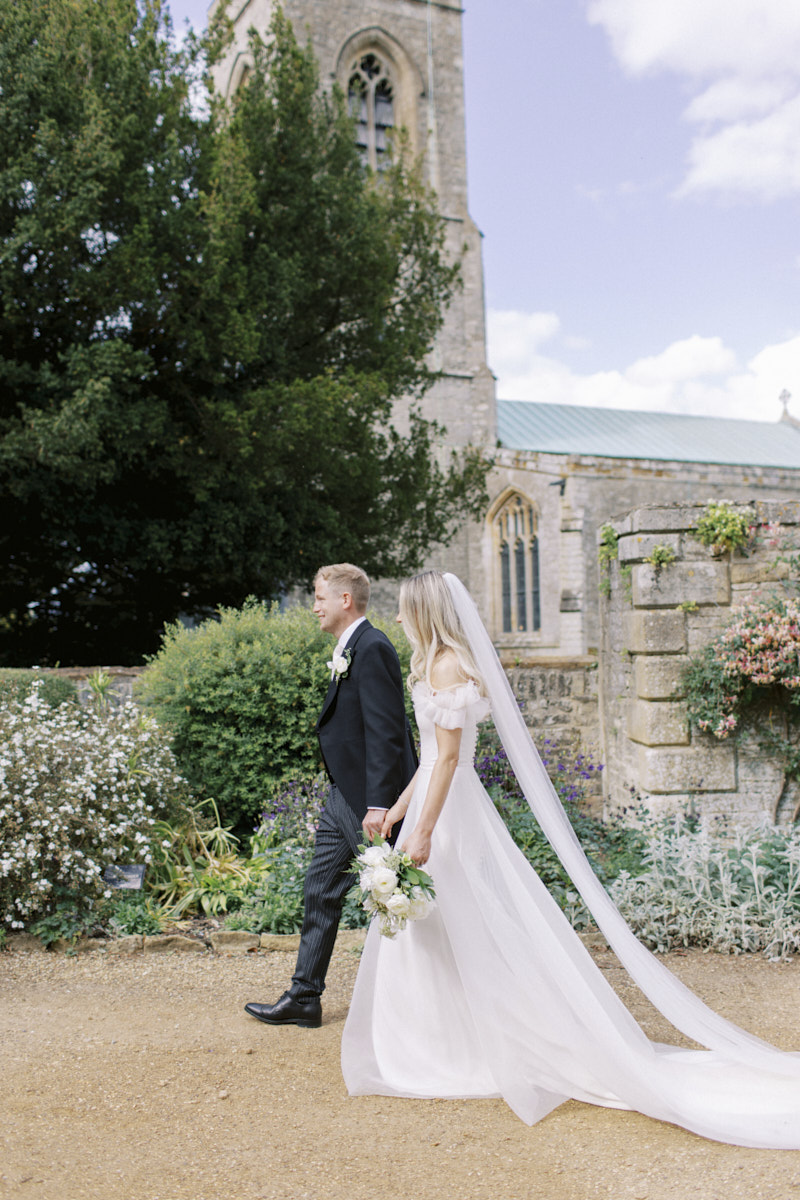 bride and groom walking at the castle ashby gardens in Northampton