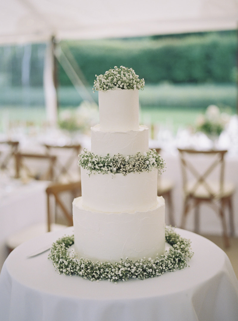 minimal four tier wedding cake in white colour decorated with Gypsophila flowers