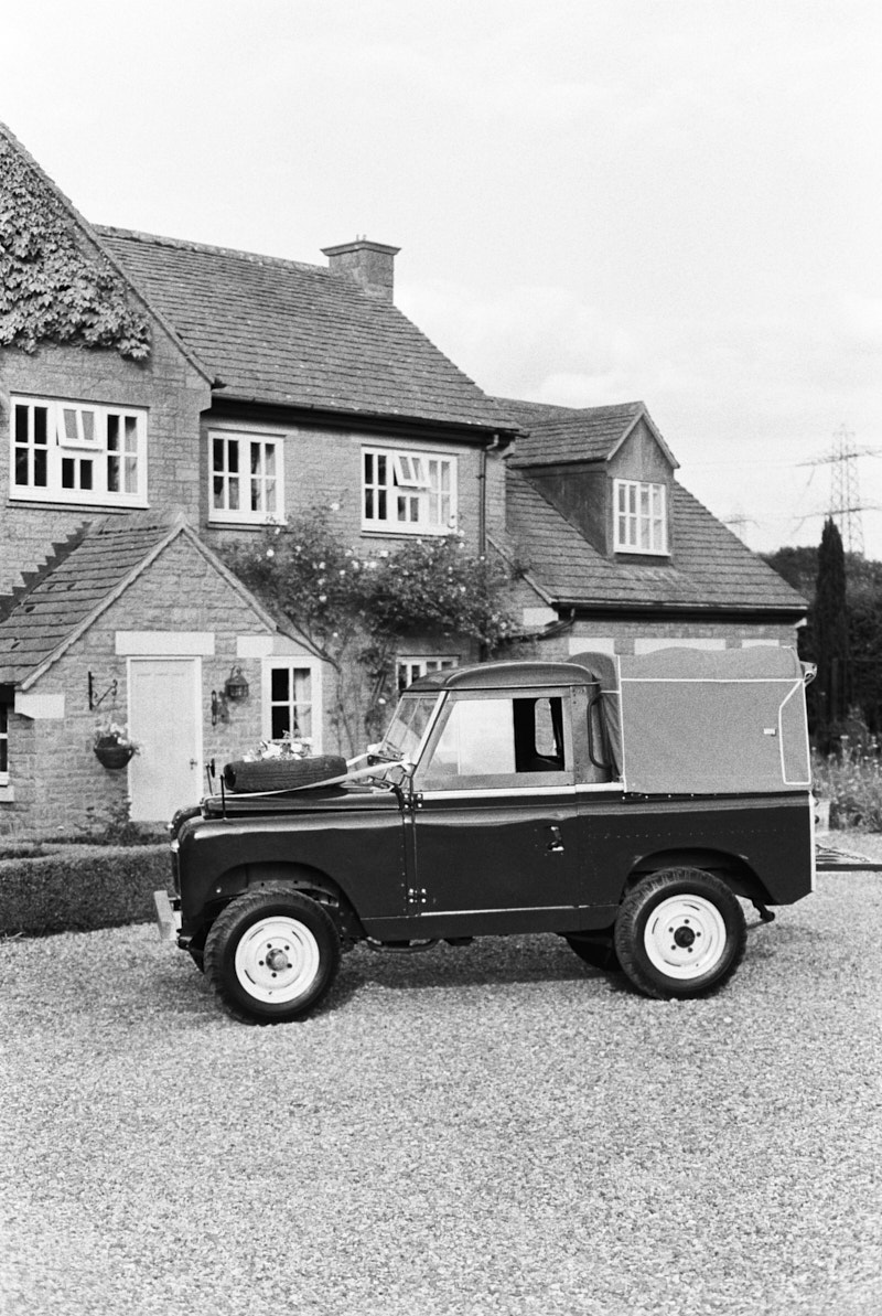 black and white film photo of the range rover wedding car 