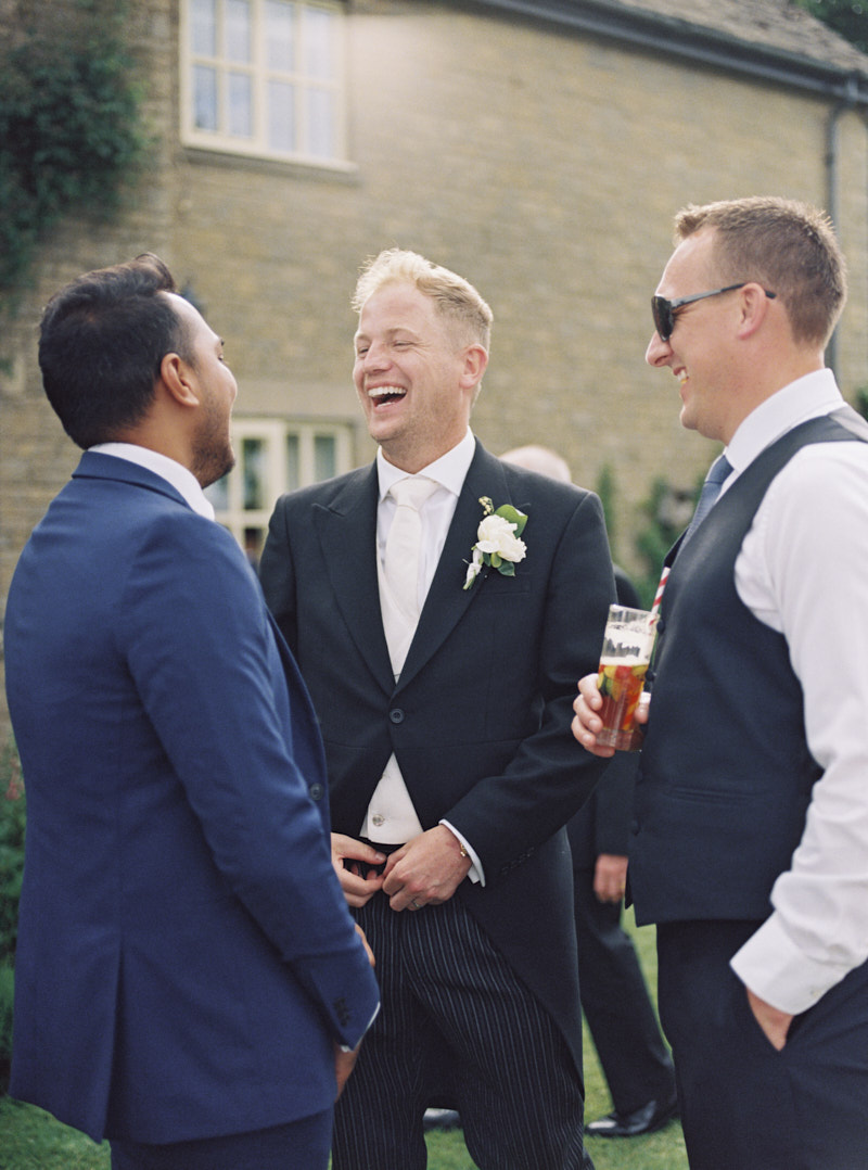 happy groom and wedding guests at the drink reception