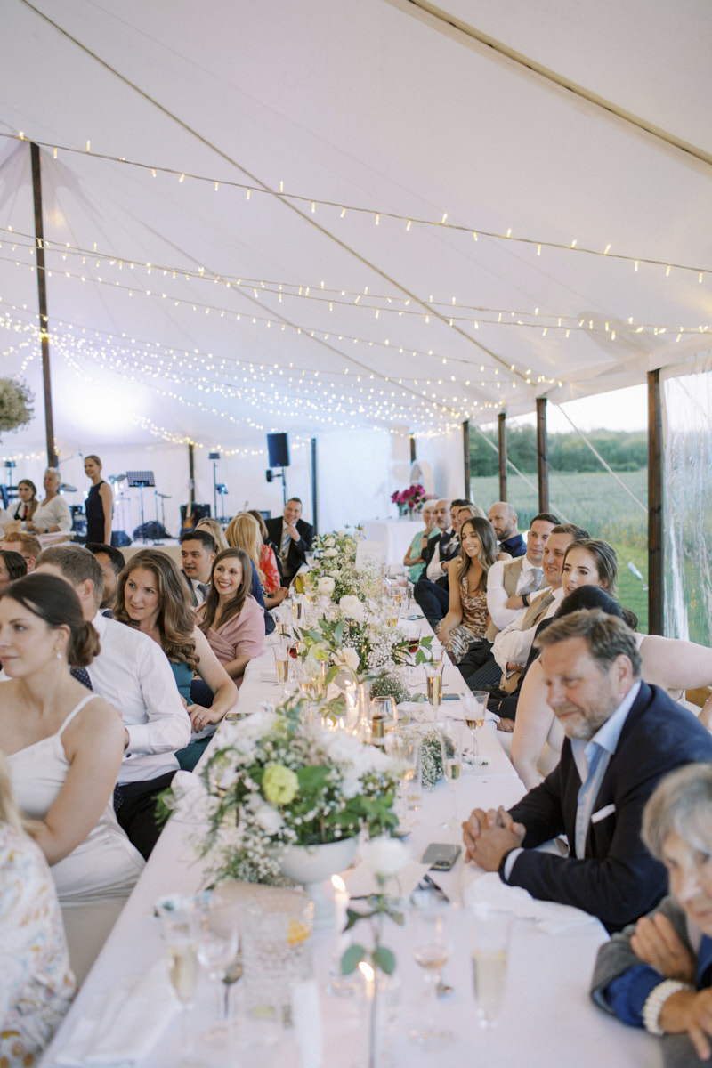 guests enjoying a time at summer marquee wedding 