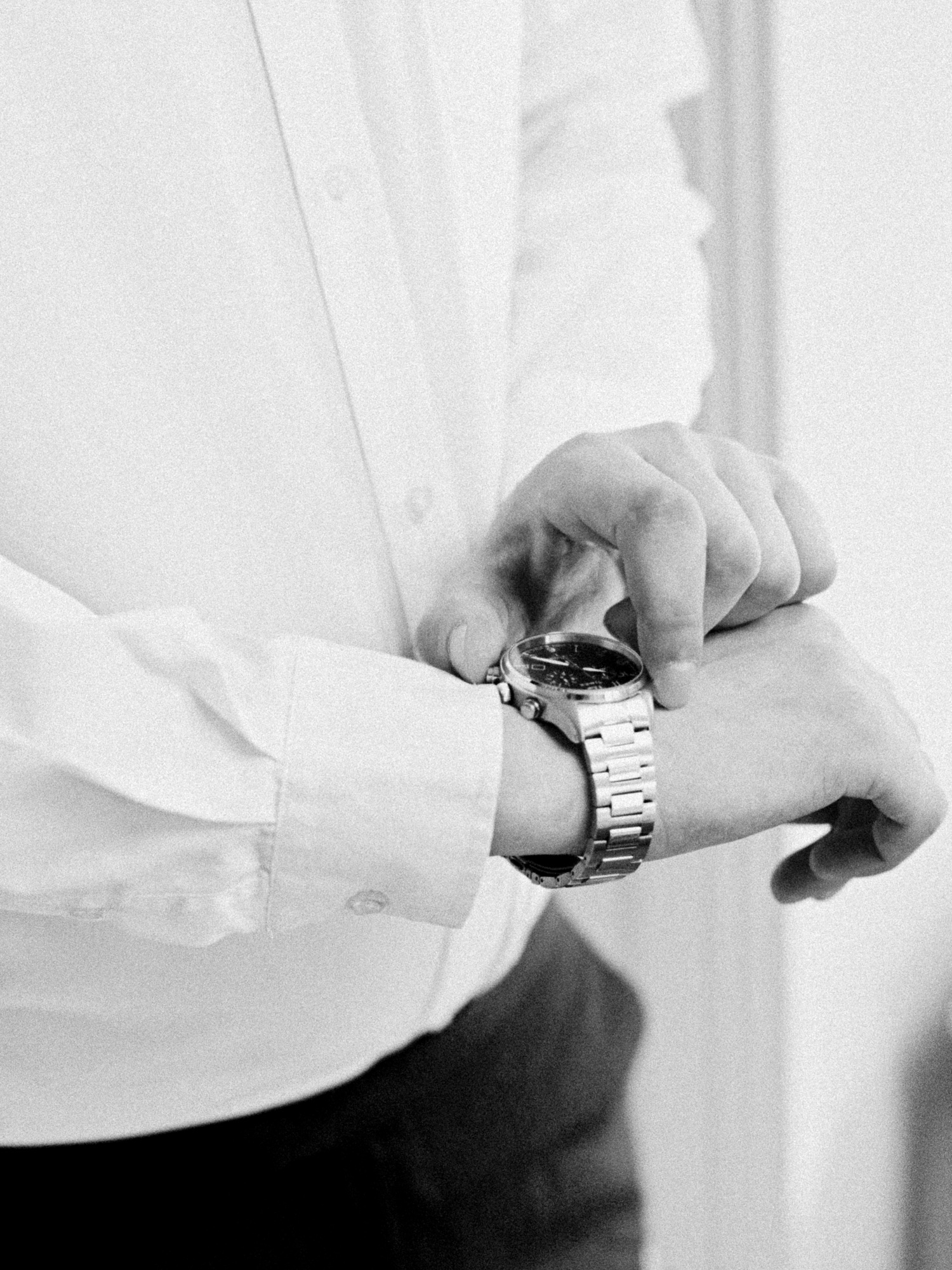 groom checking time on his wrist watch, groom getting ready on the wedding morning