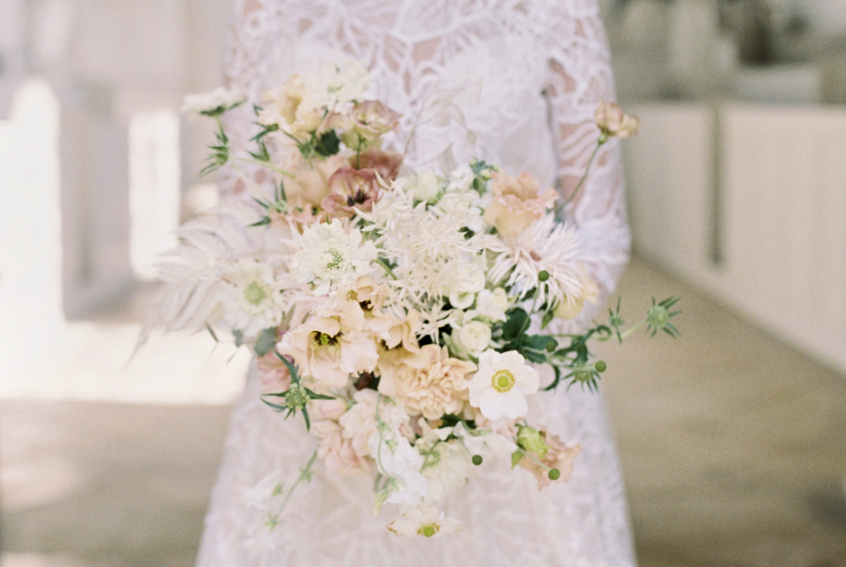 close up of bride holding blush flower bouquet, bride wear lace detail wedding gown