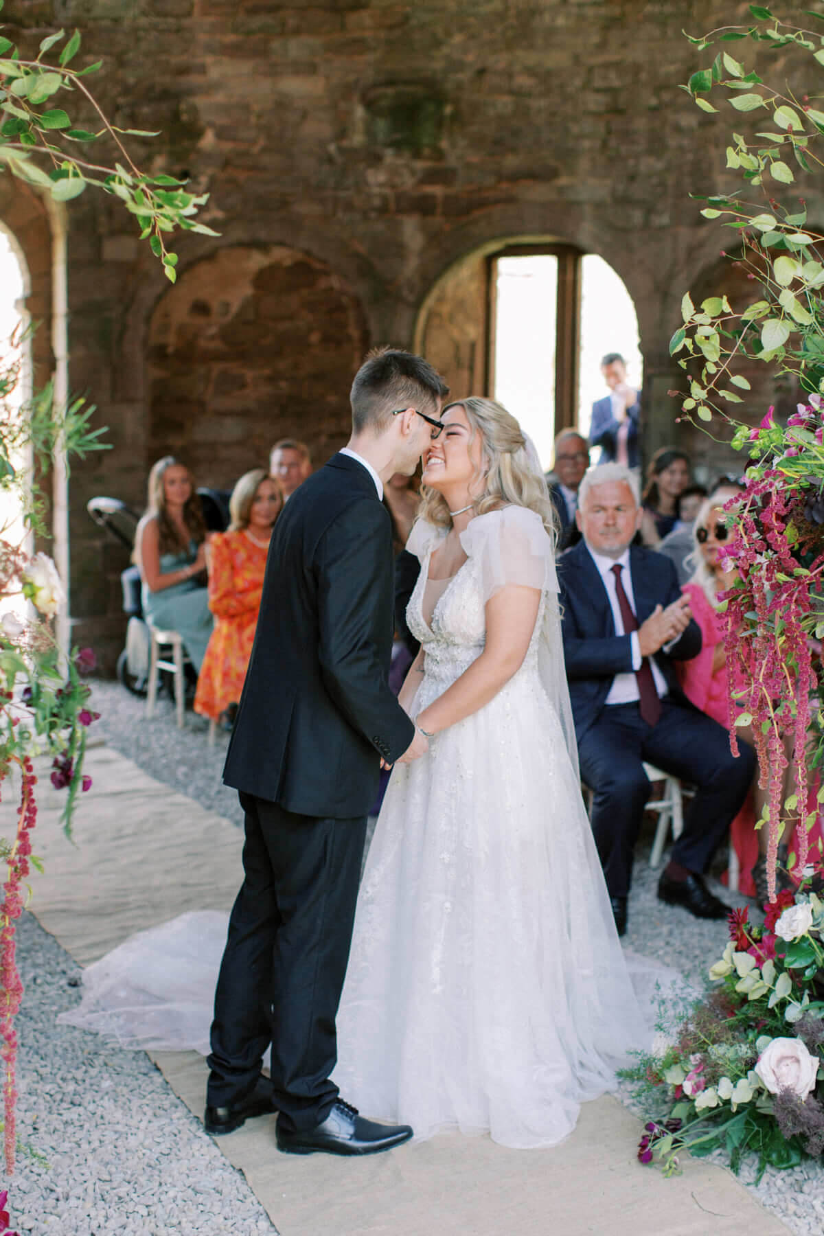 Bride and groom first kiss at an outdoor Lincolnshire wedding venue