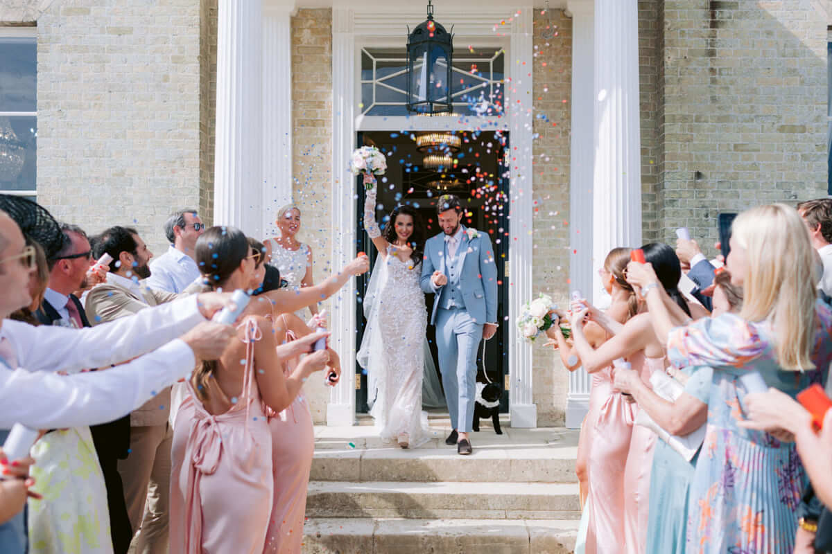 Relaxed couple portrait during comfetti showing an ideal wedding schedule for a stress-free wedding